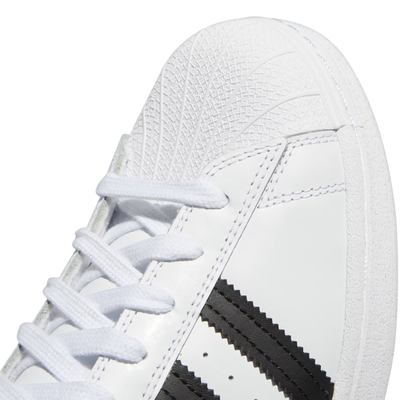 White Adidas Superstar sneaker with black stripes on a white background