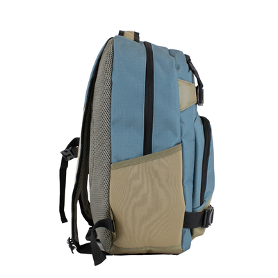 A Volcom grindstone skateboard backpack in slate blue and tan with black straps and zippers, shown against a plain white background.