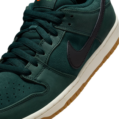 Green nike sb orange label dunk low sneaker with a black swoosh logo on a white background