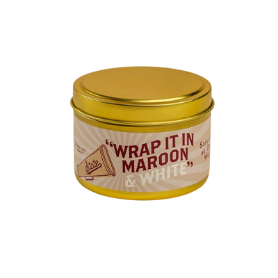 scent library by laurel merchantile Candle with wrap it in maroon and white label on a white background