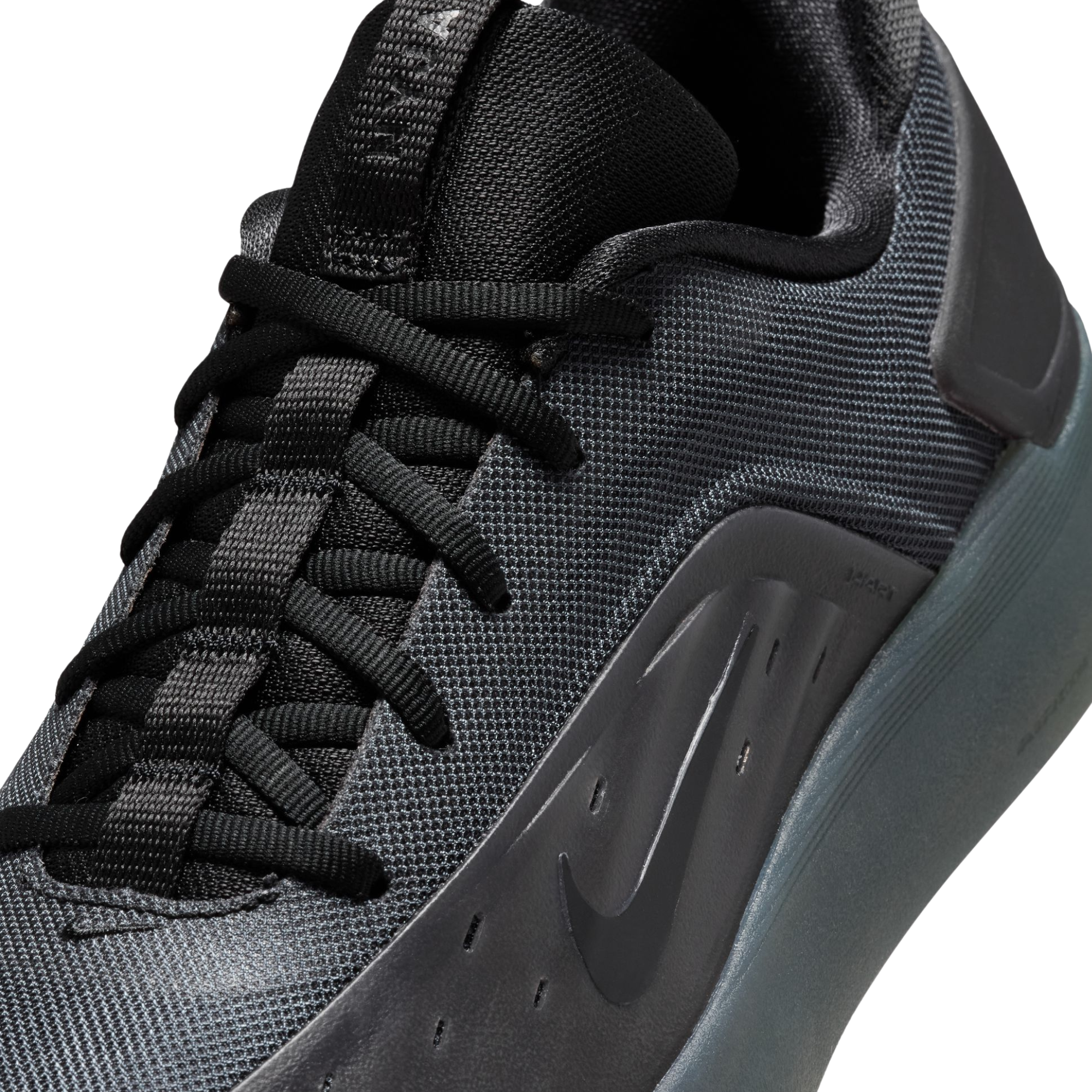 close up of A black Nike nyjah 4 skateboard sneaker with a textured synthetic upper, black laces, a black sole, and a small red pull tab on the heel, shown from a side profile against a white background.