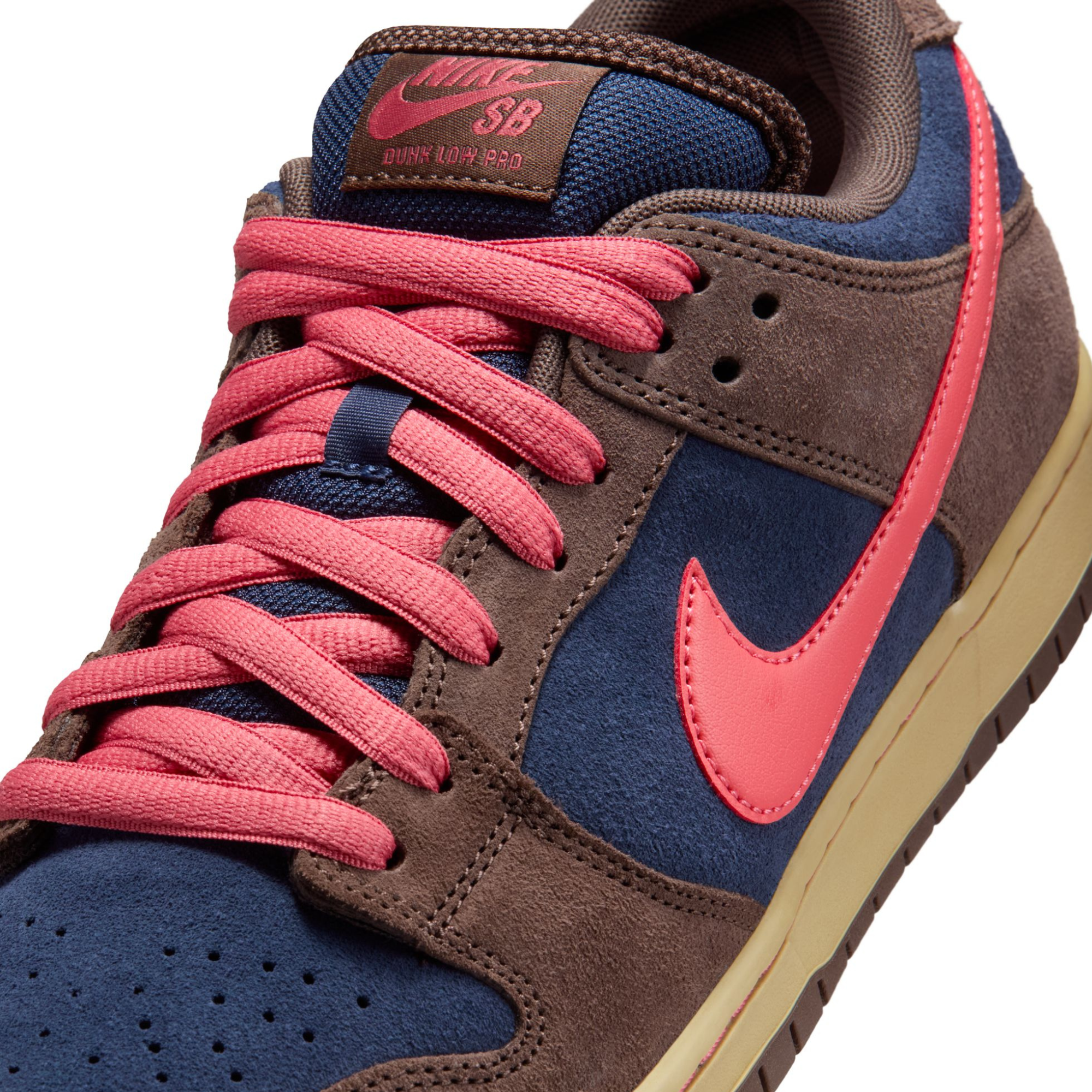 nike sb dunk low Sneaker with brown, blue, and pink color scheme on a white background