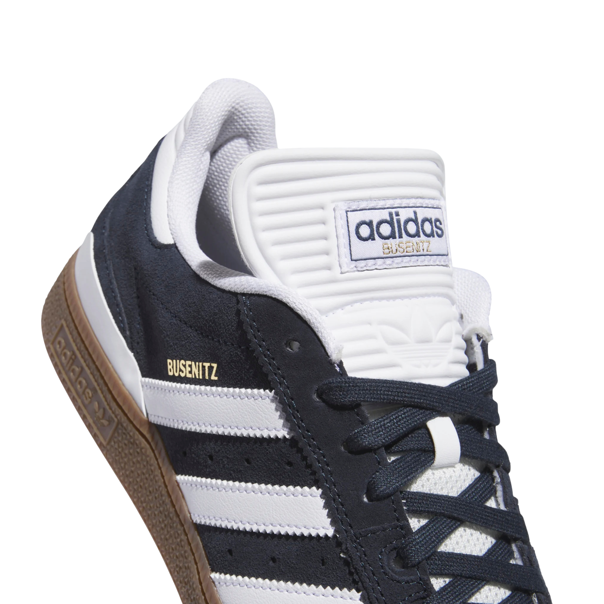 dark grey adidas busenitz skateboarding shoe with white strips and tongue and  gum sole on a white background