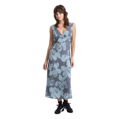 Woman wearing a sleeveless volcom grumpy sunshine floral dress on a white background