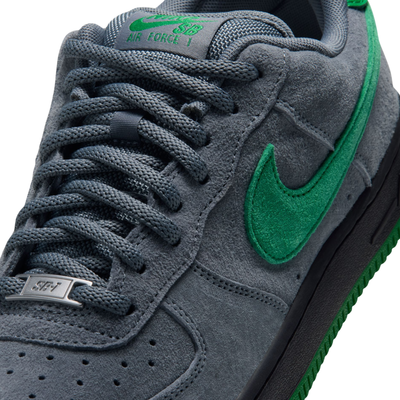 grey nike sb x nocturnal air force 1 with green swoosh and black and green sole on a white background