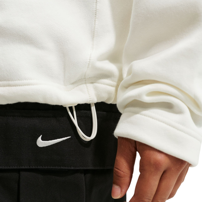person wearing white half-zip NIKE SB FC PACKsweatshirts with logos and text on a white background
