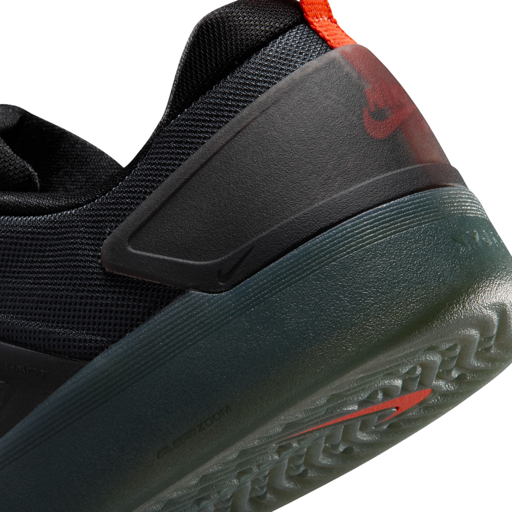 close up of A black Nike nyjah 4 skateboard sneaker with a textured synthetic upper, black laces, a black sole, and a small red pull tab on the heel, shown from a side profile against a white background.