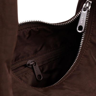 Close-up of A dark brown slouchy baggu meringue shoulder bag with a single strap, shown against a plain white background.