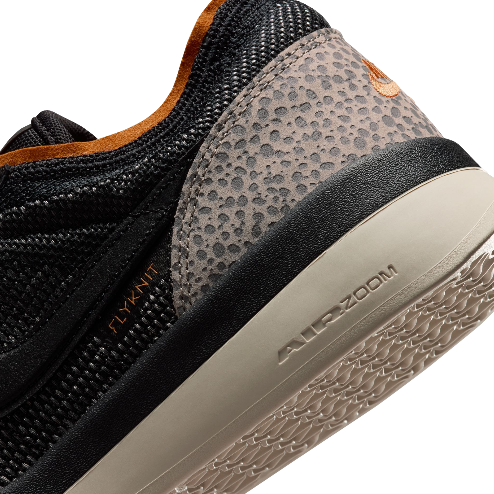 Close-up ofA Nike SB PS8 skateboard sneaker in black, orange, and gray leopard print, showing the Flyknit upper, textured gray heel counter, and a beige Air Zoom outsole on a white background.