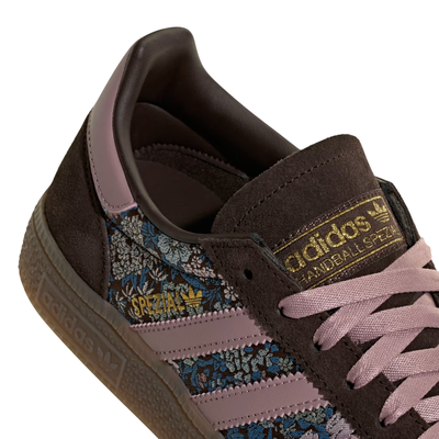 brown liberty london adidas handball spezial with brown suede and floral embroidered pattern, pink stripes and a gum sole on a white background