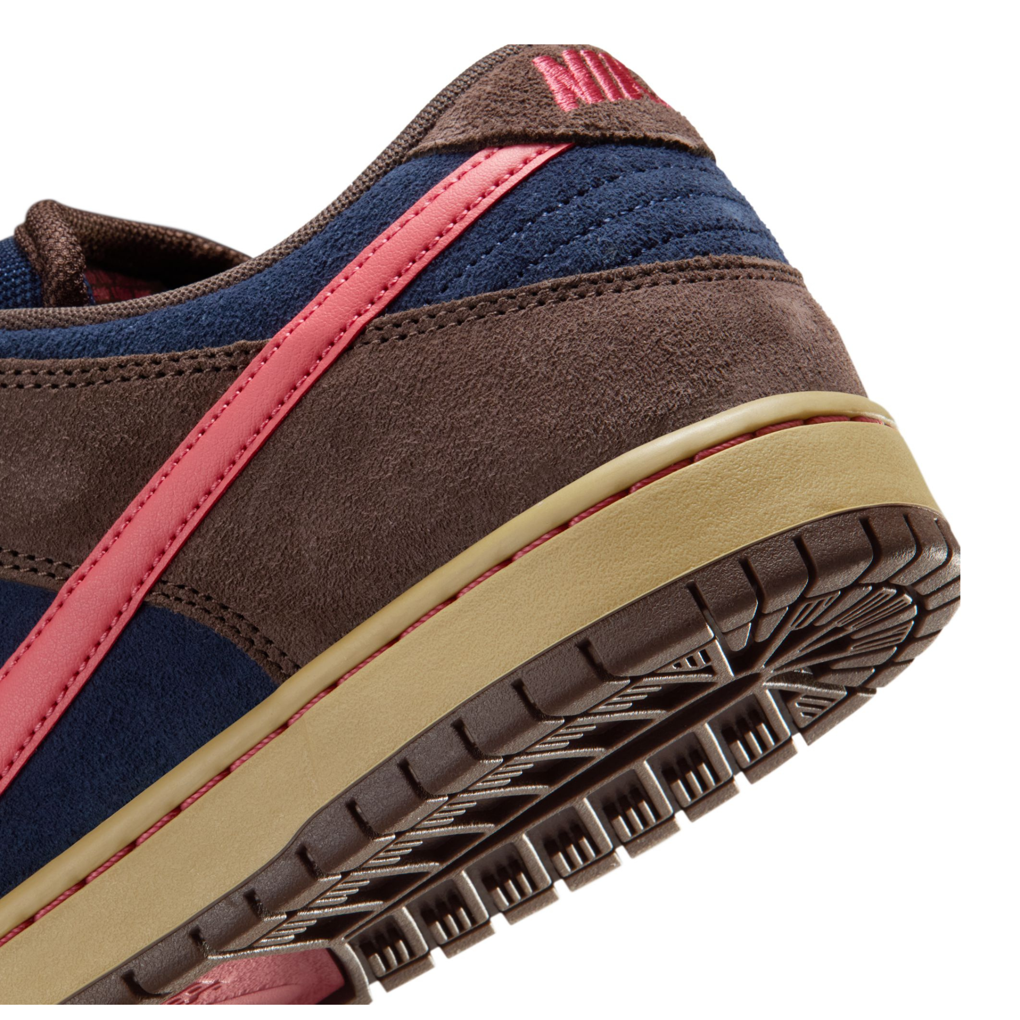 nike sb dunk low Sneaker with brown, blue, and pink color scheme on a white background