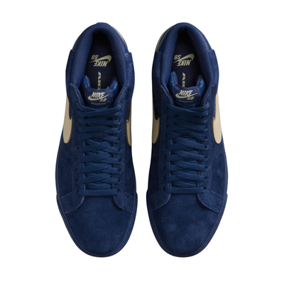 A high-top Nike sb Blazer skateboard sneaker in navy blue suede with a beige Swoosh logo and matching navy laces, shown from a side profile on a white background.