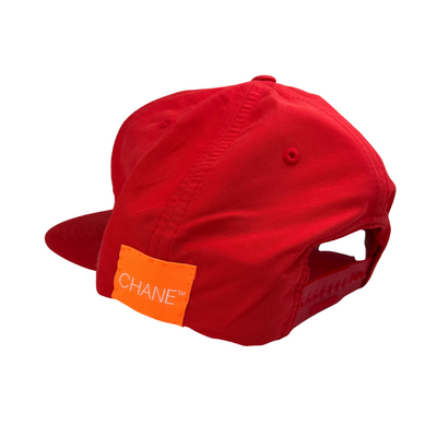 Red cap with an orange patch displaying 'CHANE' on a white background
