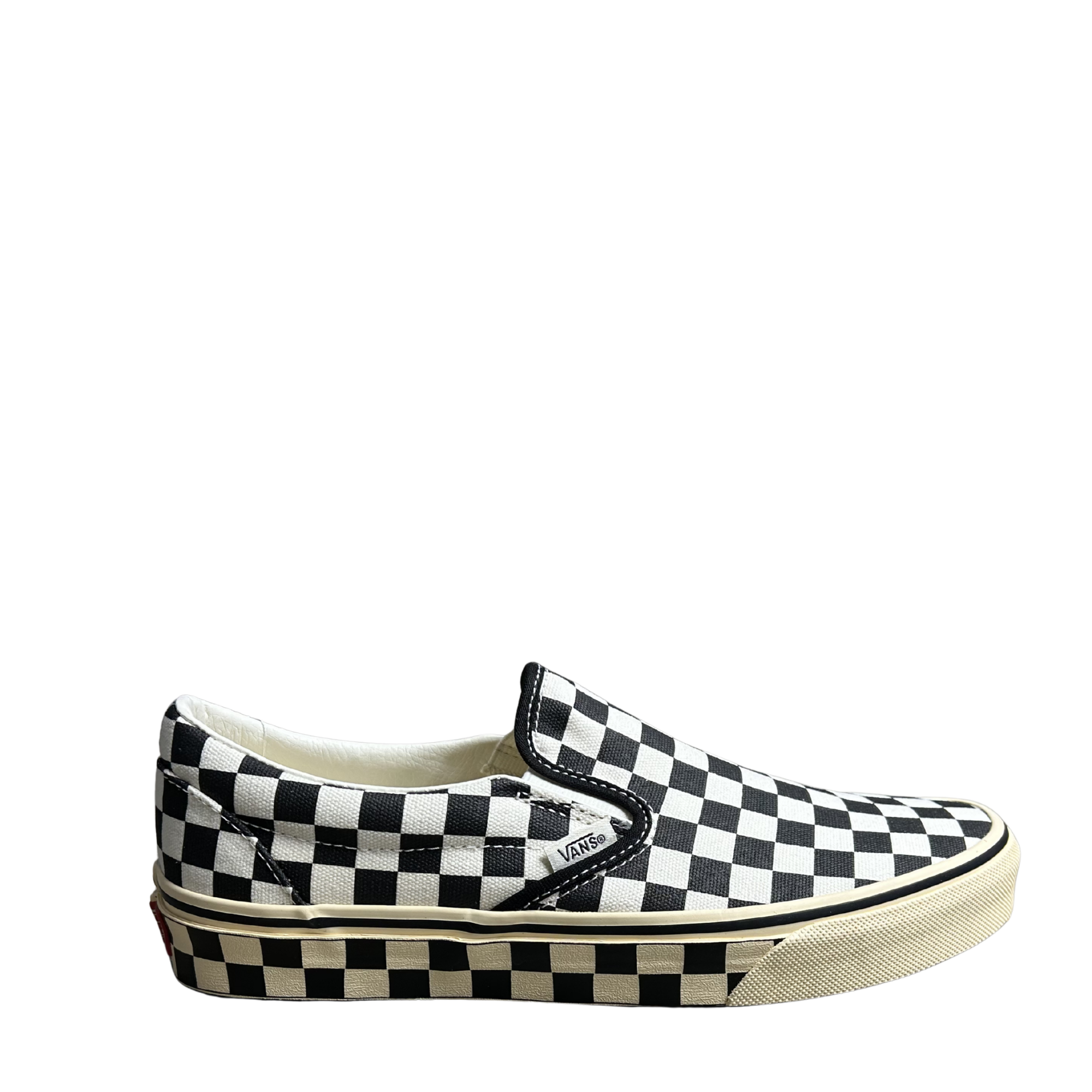 Black and white checkered slip-on Vans shoe with an off-white and black checkerboard sole on a white background