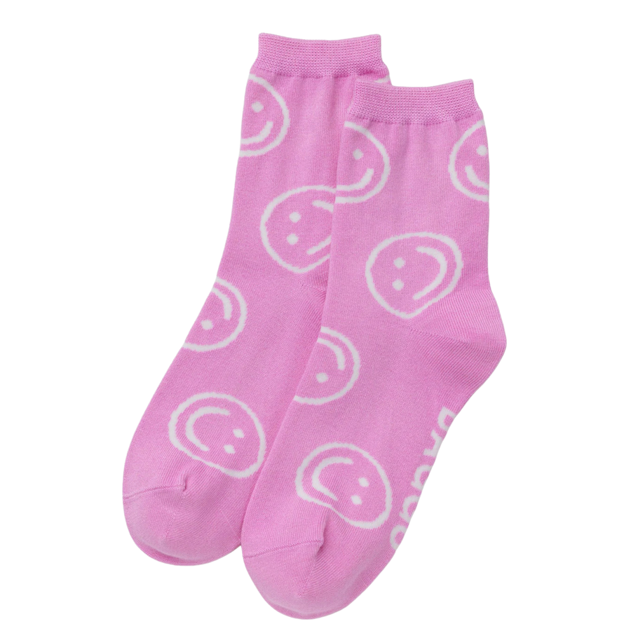 pink baggu crew socks with white smiley faces on a white background