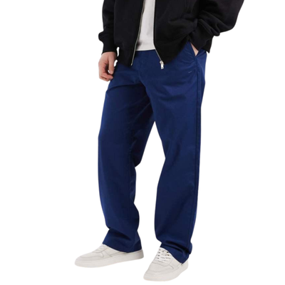 Person wearing blue vans pants and a black jacket on a white background