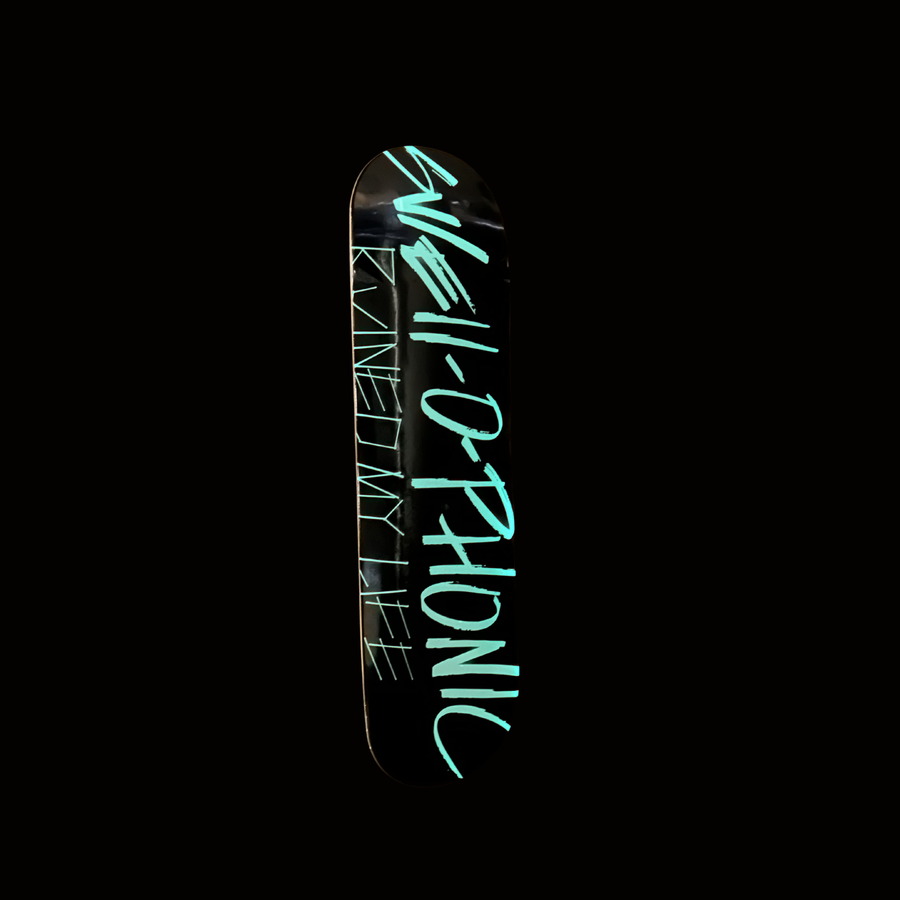 Black skateboard deck with SWELL-O-PHONIC ruined my life in white text on a white background