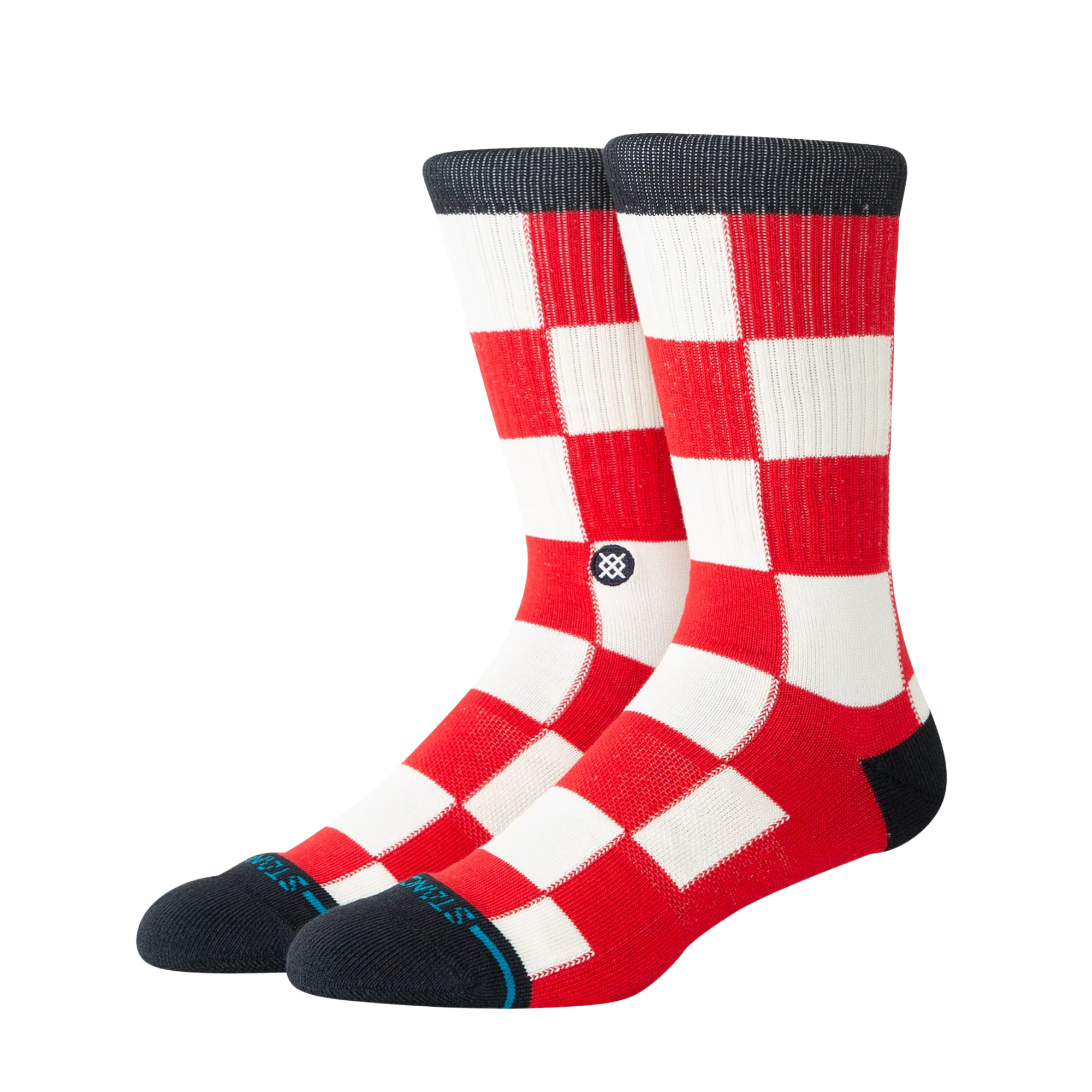 A pair of stance chaturanga crew socks with a red and white checkered pattern, featuring black cuffs, heels, and toes, and a small circular Stance logo on the side.