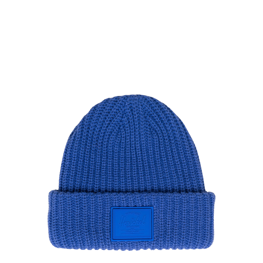 blue knit herschel douglas rubber patch beanie on a white background