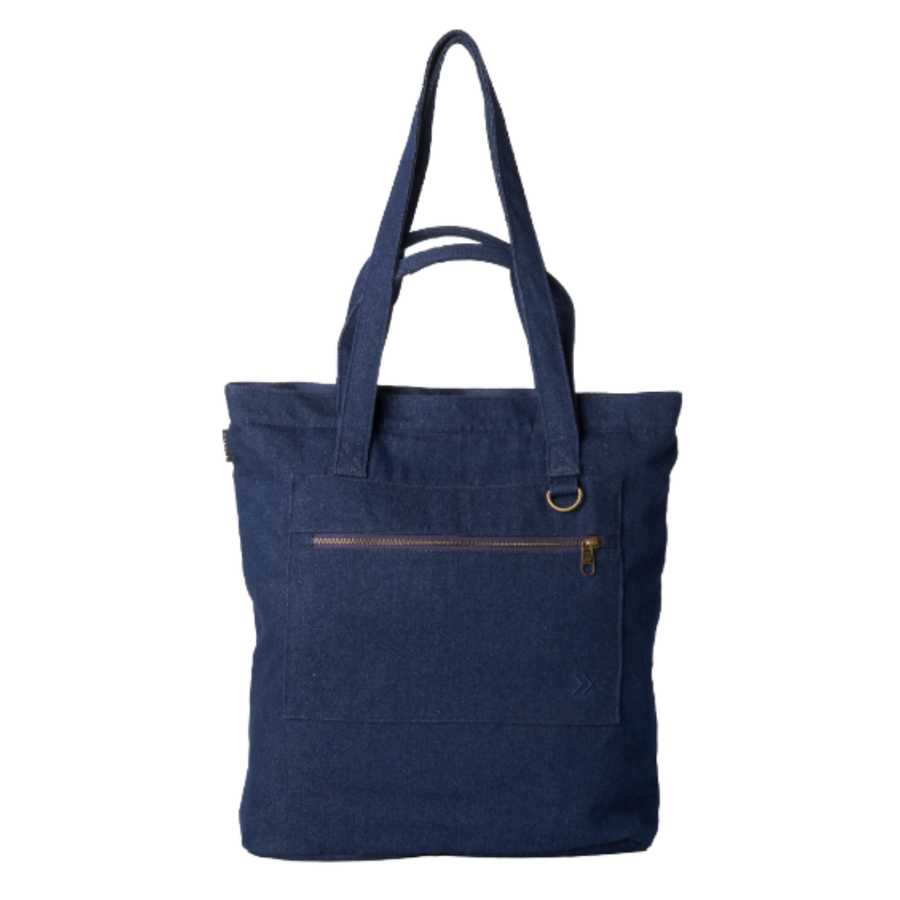 A dark blue canvas tote bag with dual shoulder straps, a front zippered pocket, and a small brass ring detail, shown against a plain white background.