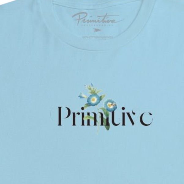 A light blue short-sleeve crewneck t-shirt with a 'Primitive' logo printed on the chest, displayed flat against a solid white background.