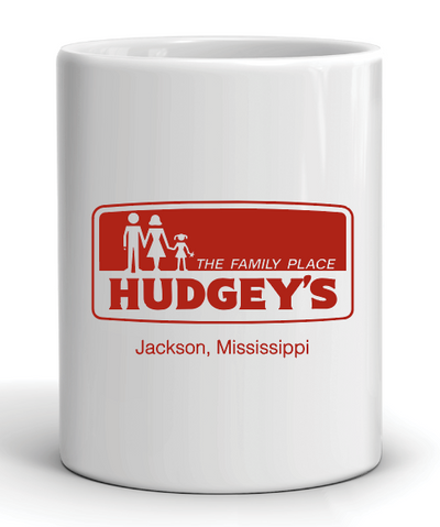 White mug with red hudgey's the family place jackson mississippi graphic and text on a white background