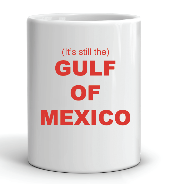 White mug with red text stating 'It's still the Gulf of Mexico' on a white background