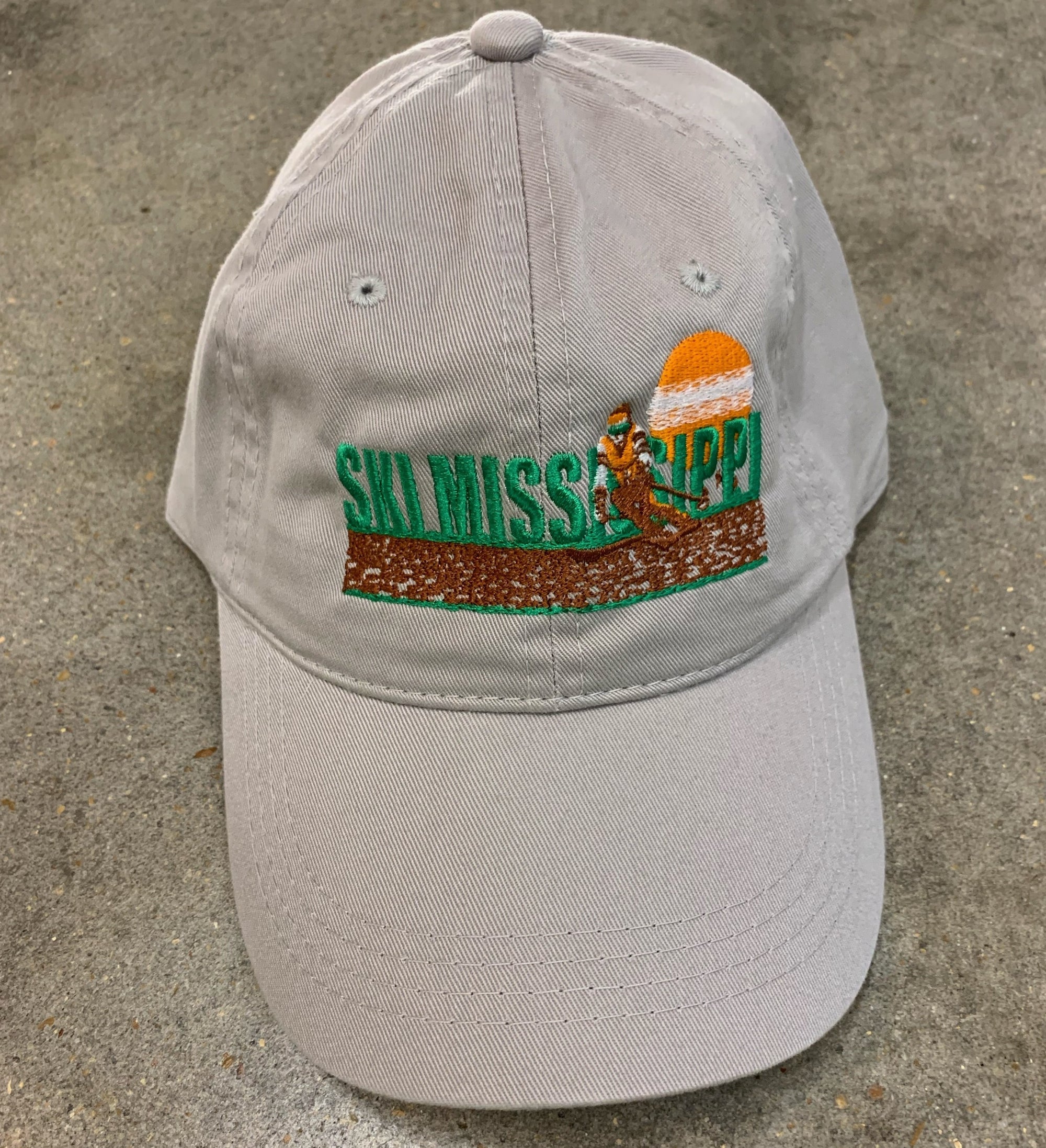 grey embroidered hat featuring the ski mississippi logo in green brown and orange
