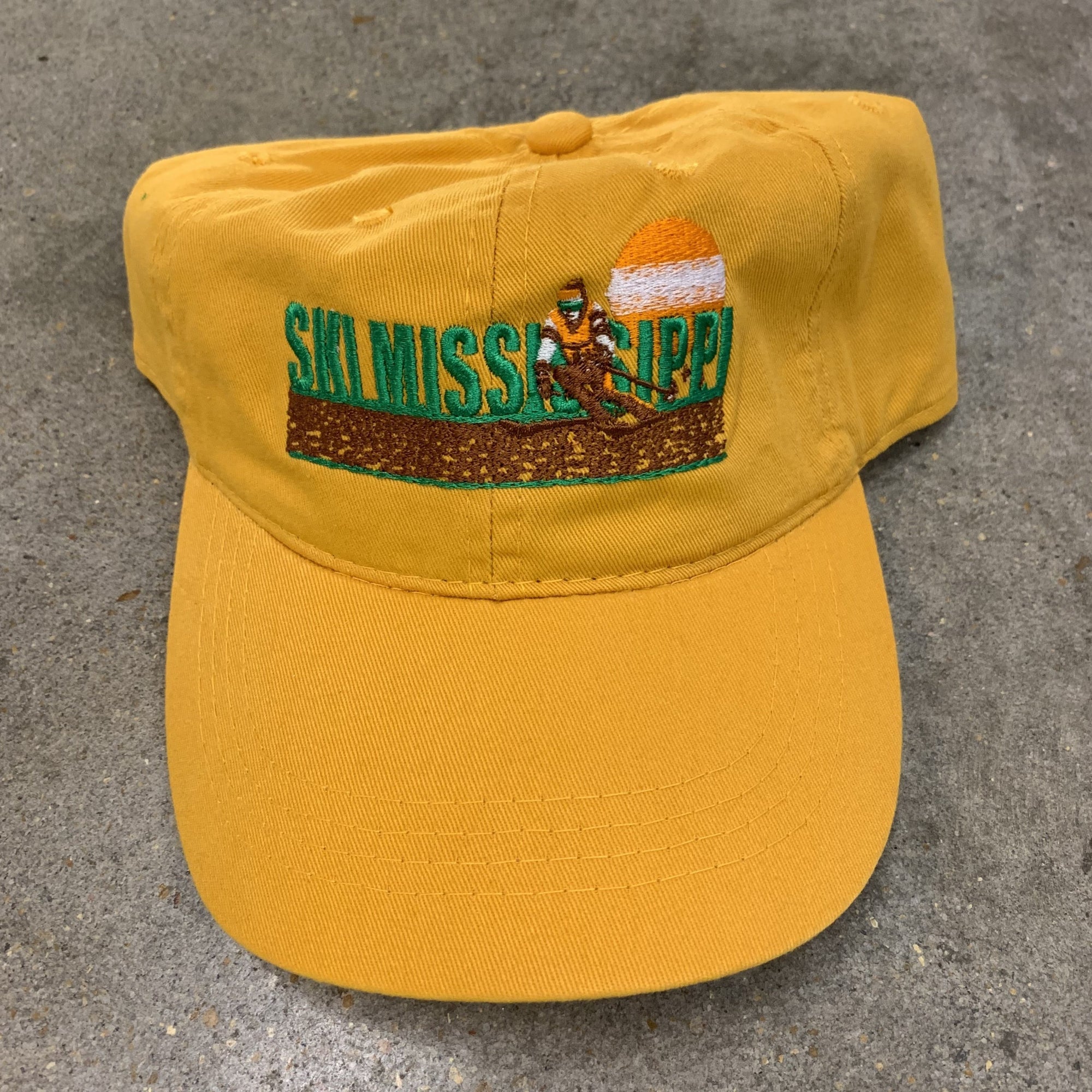 yellow embroidered hat featuring the ski mississippi logo in green brown and orange