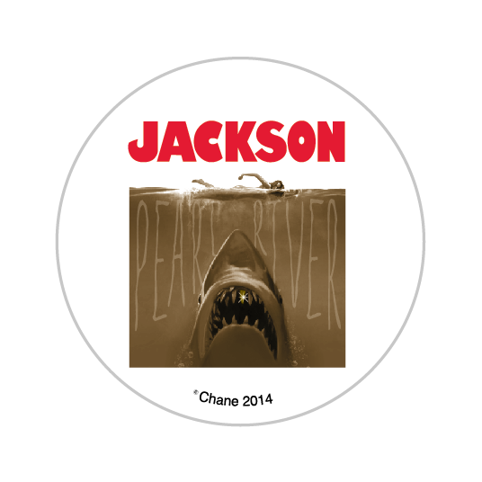button featuring the jaws shark with a gold tooth in the pearl river