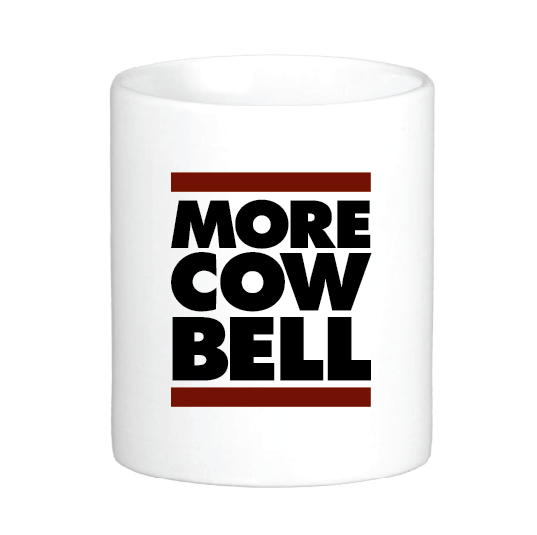 coffee mug featuring the slogan more cow bell in between two bars
