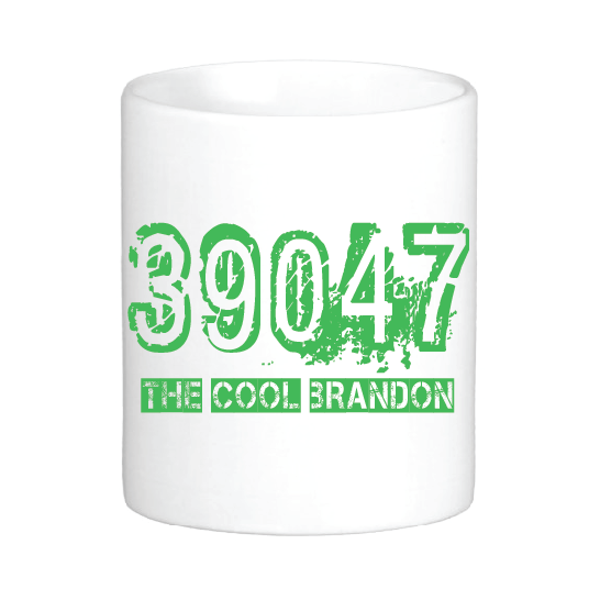 A white mug that reads "39047 The Cool Brandon" in green, in a way that appears it was spray-painted on.