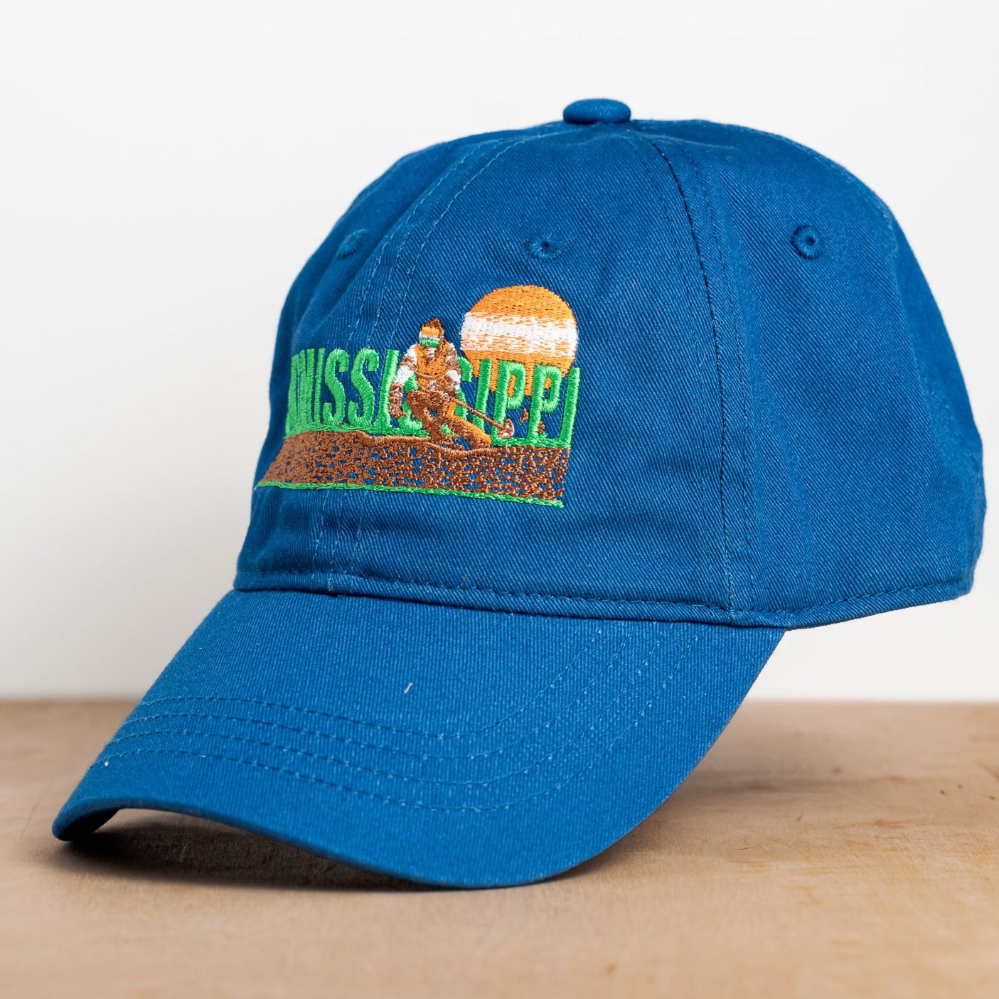 royal blue embroidered hat featuring the ski mississippi logo in green brown and orange