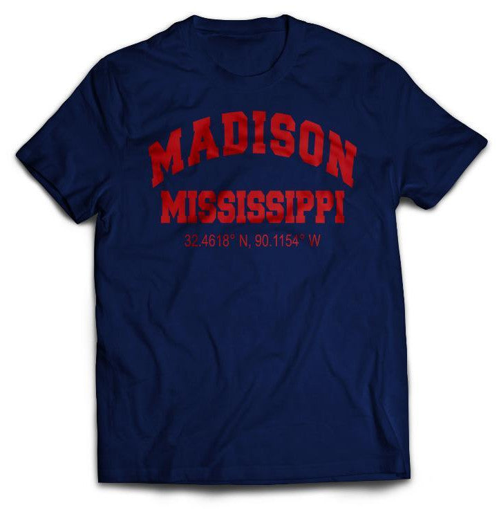 A navy blue shirt that reads "Madison Mississippi 32.4618 N, 90.1154 W" in red.