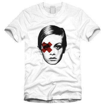 white tee shirt featuring iconic super model twiggy or perhaps edie sedgwick with a red X over her right eye