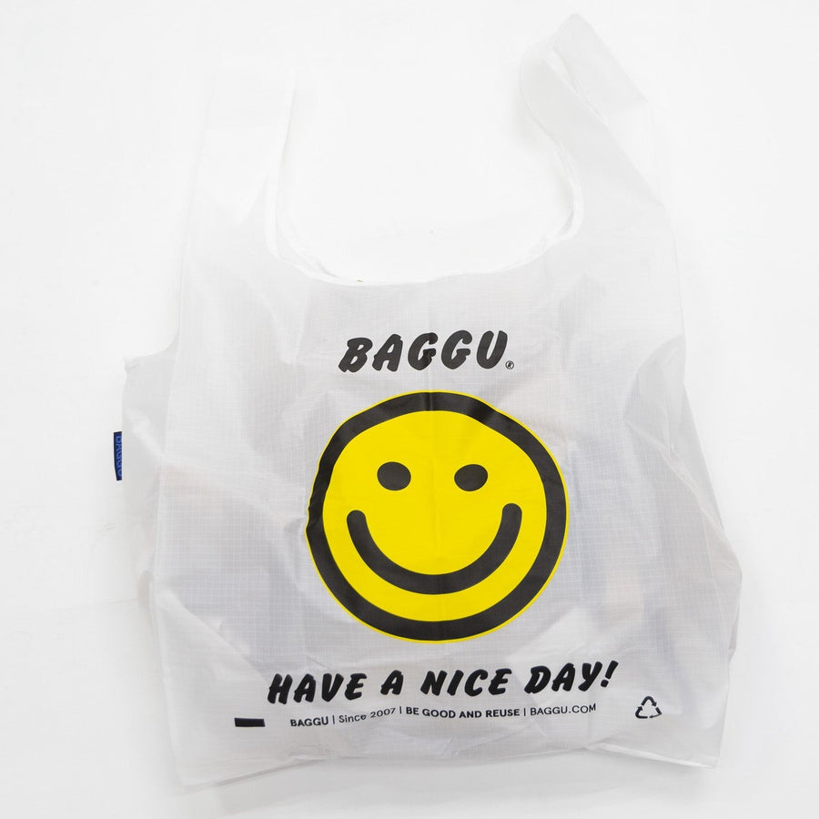 white Baggu Standard Reusable tote Bag with yellow smiley face